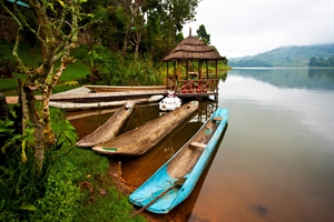 An exotic, hot non-specific destination with a brown river and some bright coloured boats.