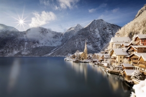 A snowy scene showing lake and mountains