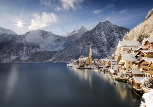 A snowy scene showing lake and mountains